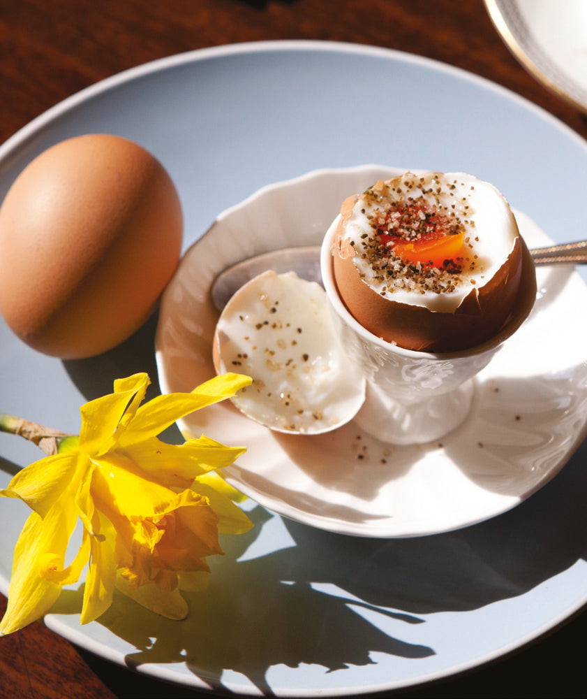 An open boiled egg in an egg cup sprinkled with Seagreens Mineral Salt