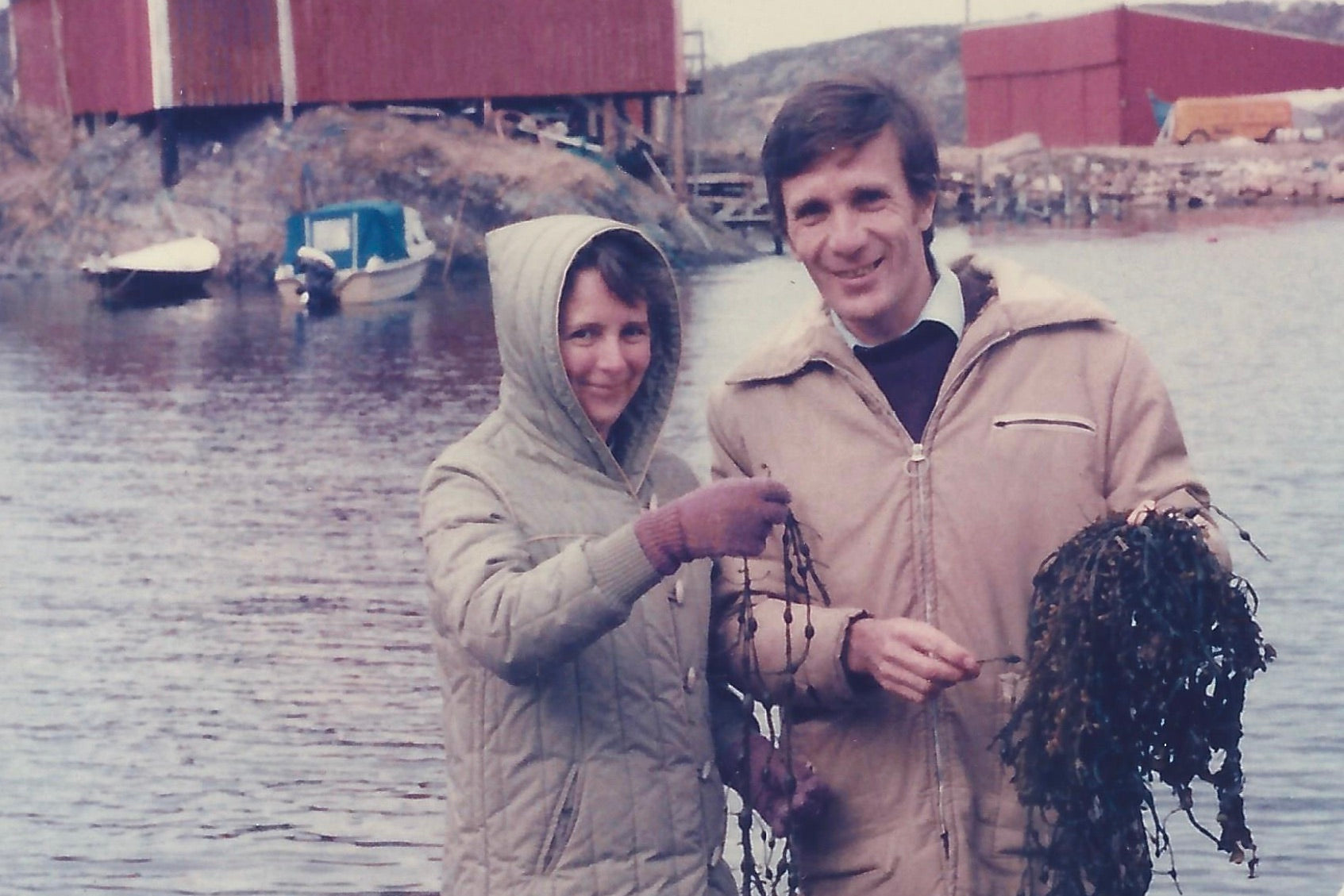 Grahame and Edna West at the Algea seaweed processing plant in Norway 1985, standing on a boat ramp holding fresh seaweed