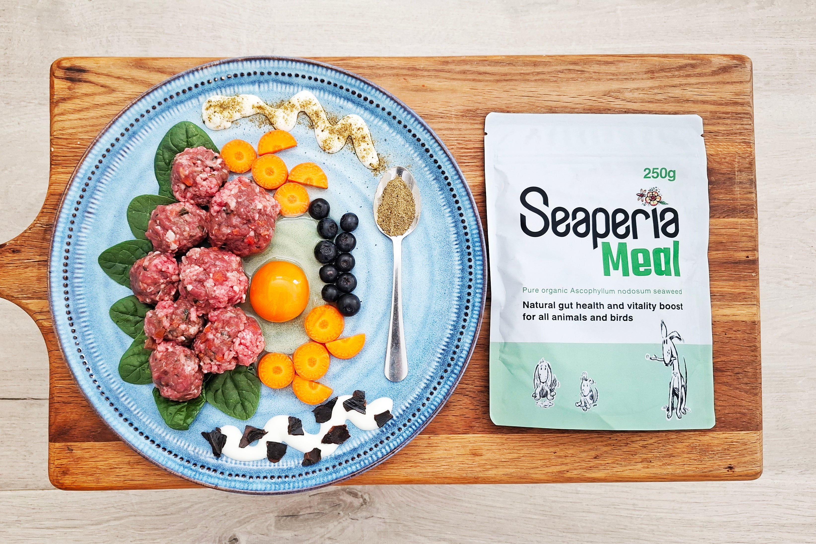 Fresh feeding dietary dog food on a plate with a Seaperia meal ascophyllum kelp seaweed for dog and animal dental health.