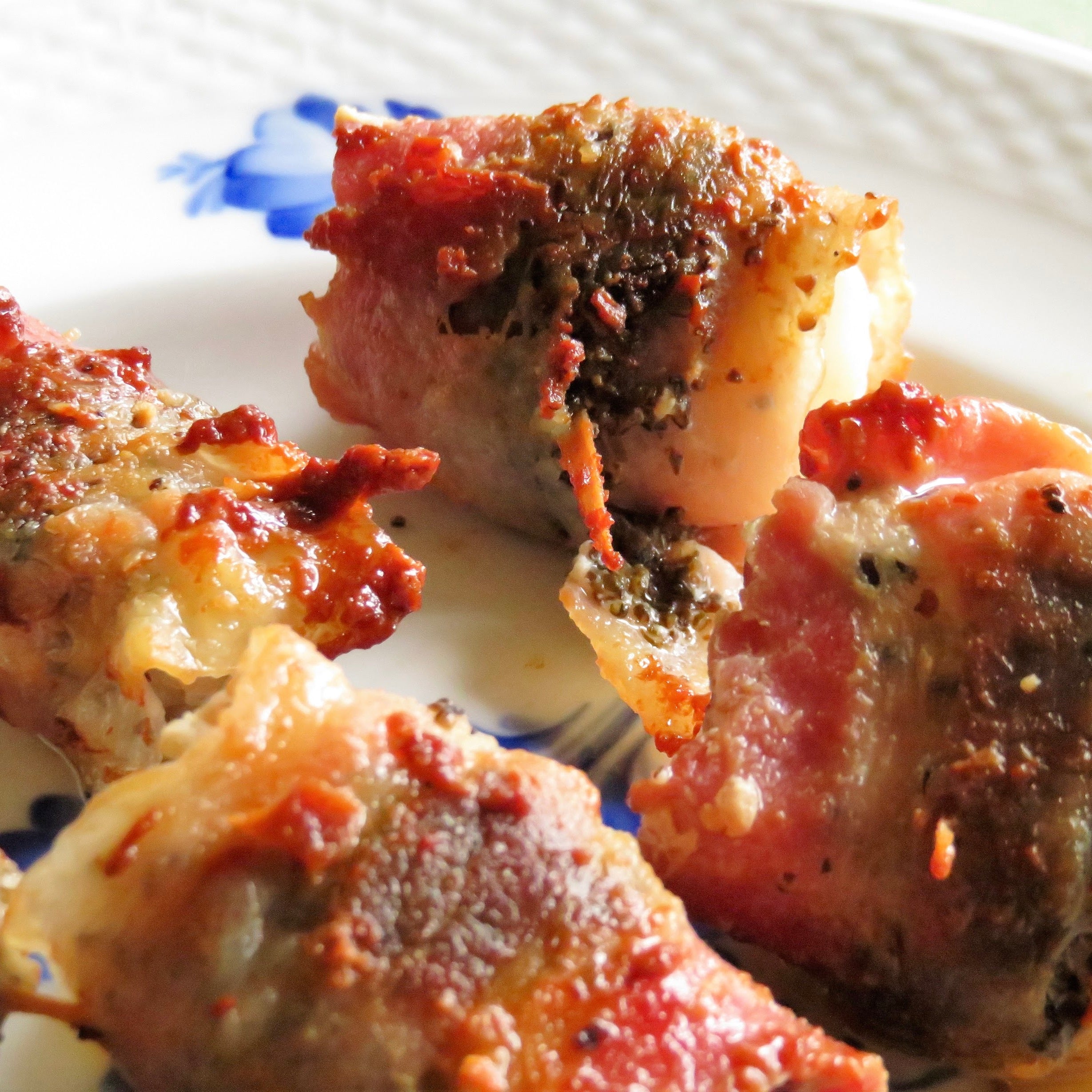 A close up of bacon wrapped chicken thighs with a seaweed crust recipe.