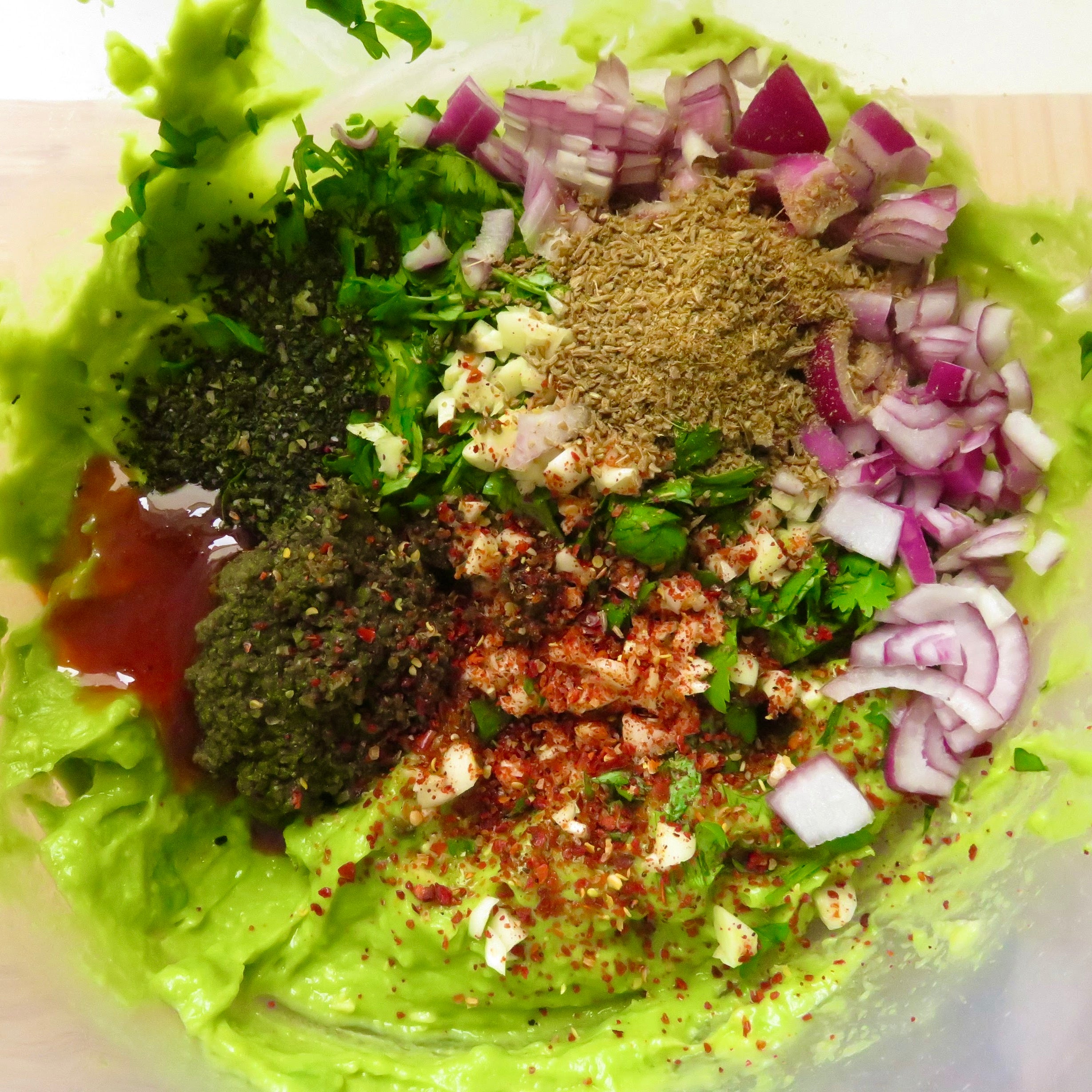 A close up of a bowl of guacamole ingredients with Seagreens seaweed recipe.